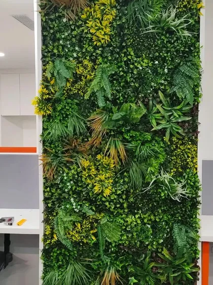 This is how we bring life to the modern workplace. A floor-to-ceiling artificial green wall acts as a natural divider and a stunning focal point in this open-plan office, helping to improve acoustics and create a more calming, productive atmosphere.