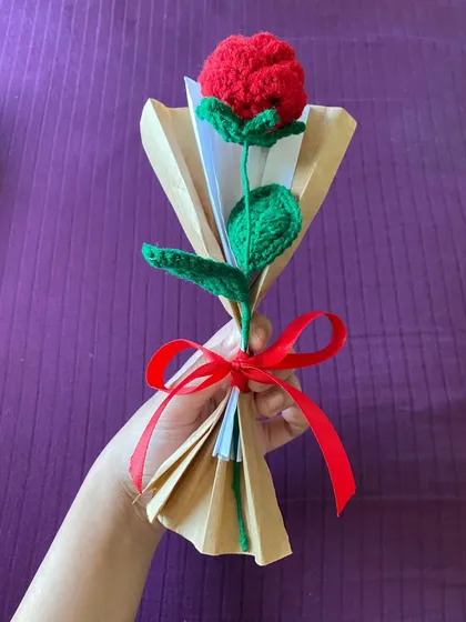 A single, handcrafted crochet red rose, beautifully wrapped and ready for gifting. Unlike a real rose, this one is a symbol of everlasting love, perfect for Valentine's Day, anniversaries, or just because.