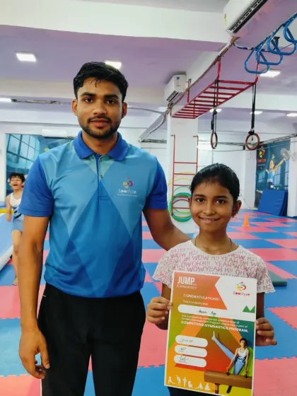 Little steps to big achievements. This student proudly holds her "JUMP" program certificate.