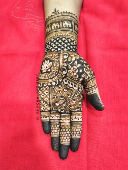 A classic Indian mehendi design for one hand. The pattern includes an elephant band, lotus motifs, and full finger coverage for a traditional look.