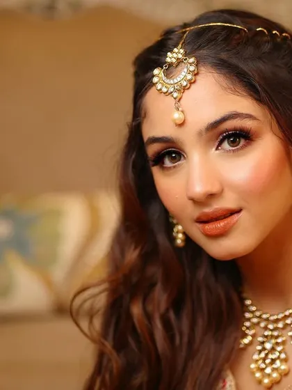 A stunning close-up that highlights the flawless skin and captivating eye makeup.