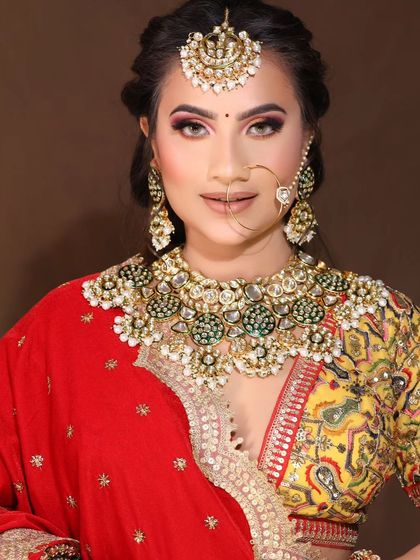 A bride pairs a multi-colored blouse with a heavy Kundan and green bead necklace. This shows how versatile my jewellery is for various bridal outfits.