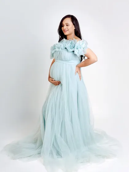 A full-length studio shot of our Elsa gown. The layers of light blue tulle create a beautiful, airy effect that photographs wonderfully.