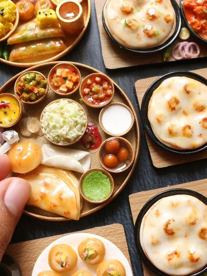 A close-up of a North Indian thali, showing the variety of curries, bread, and sweets.