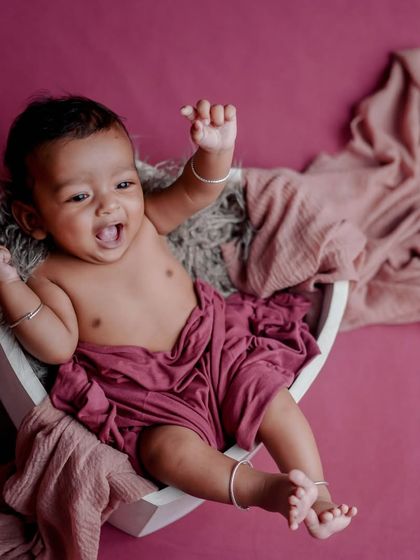 A roar of happiness. I love capturing these big, expressive moments. This baby is having the best time in this simple, heart-shaped prop.