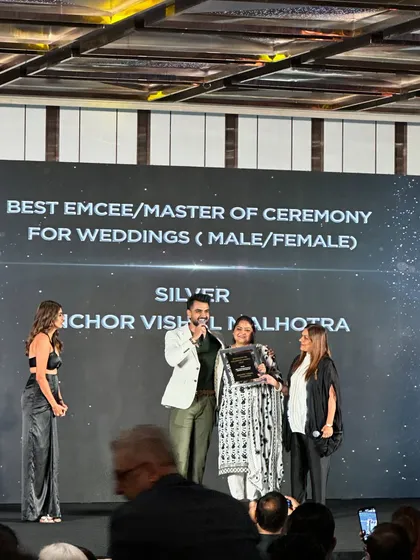 A side view of the award presentation, capturing the photographers and the audience. It was a night to remember.