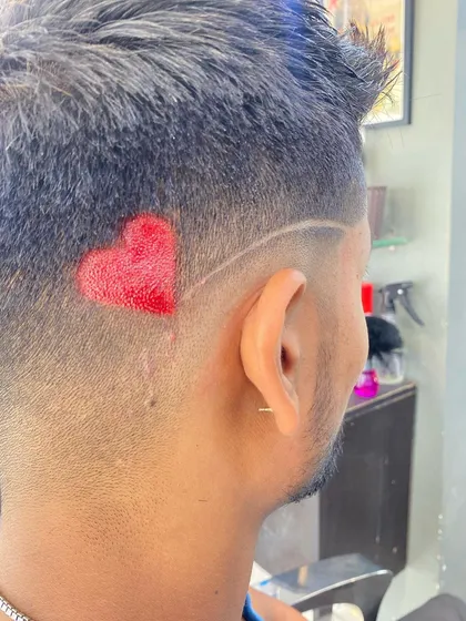 A close-up of the airbrushed red heart design, showing the texture and detail of the temporary color.