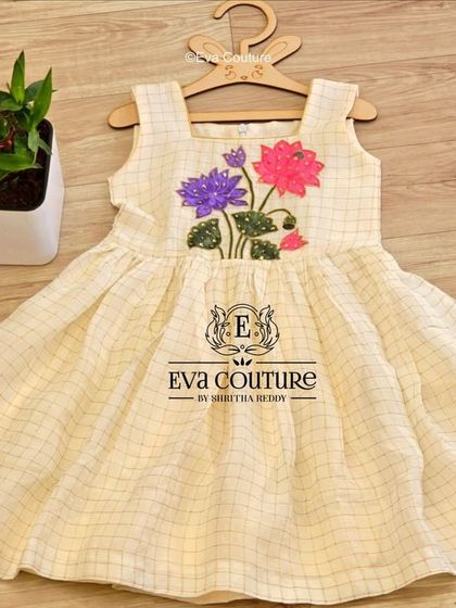 A sweet off-white checked frock with lotus embroidery, perfect for summer events and available in my ready stock.