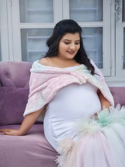 A close-up of our rainbow pastel gown. The soft, fuzzy shawl adds a cozy and sweet touch, perfect for a winter-themed or indoor shoot.