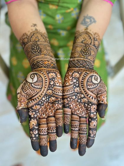 A stunning semi-bridal design featuring bold peacock motifs on the palms. The use of negative space makes the peacocks the star of the show, creating a modern and artistic look.