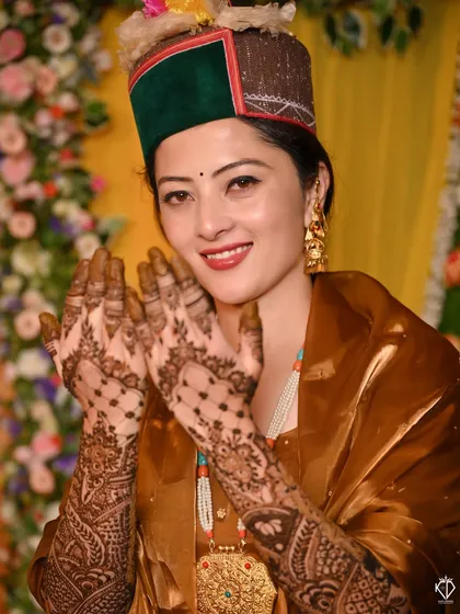 A joyful portrait of the bride in her traditional Himachali attire for the Mehandi ceremony.