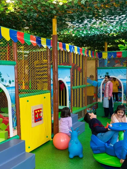 A full view of the play area, showcasing the vibrant colors and variety of activities available, from the ball pit to the climbers and toddler toys.