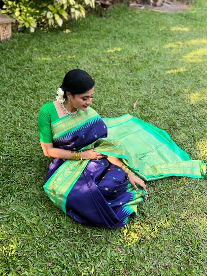 A graceful pose on the lawn, showcasing the beautiful flow of the saree.