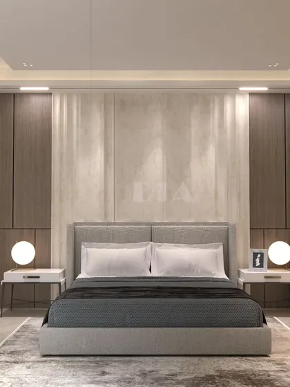A minimalist bedroom centered around symmetry and texture. The bed is framed by wood panels and a central textured stone-like wall, with simple globe lights on either side providing soft, ambient illumination.