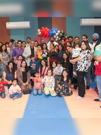 A birthday is a celebration for the whole family. I ensure there's space and fun for everyone, making it a joyous occasion for kids and adults alike, as seen in this big group photo.