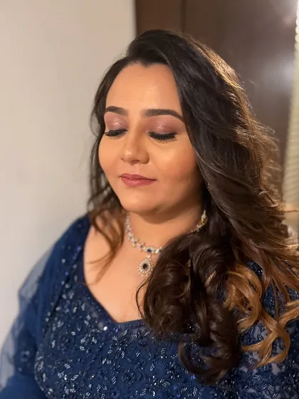 A close-up of Anisha's eye makeup, featuring a soft pink shimmer on the lids and defined eyeliner.