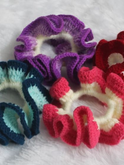 My colorful ruffled scrunchies laid flat. They are super stretchy and gentle on your hair.