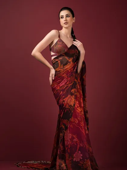 A full view of the printed saree, showcasing its rich, earthy tones and fluid drape.