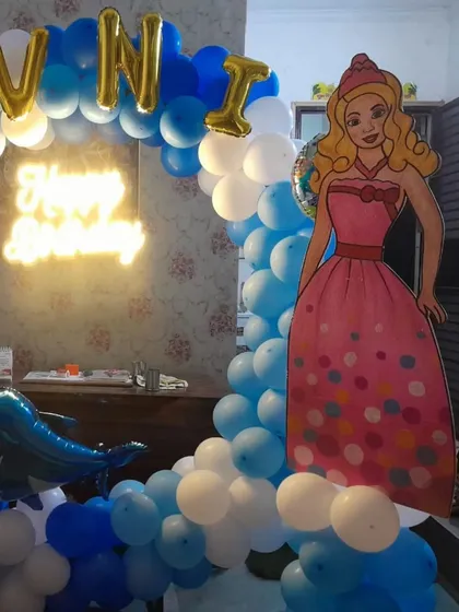 A close-up of the princess-themed balloon arch, showing the detail of the balloon arrangement and the placement of the character cutout.
