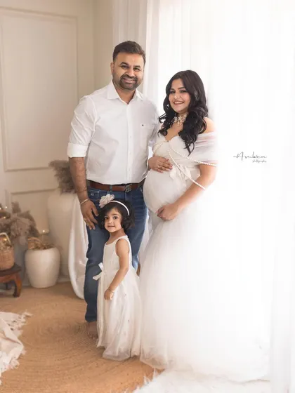 Your growing family is a beautiful story to tell. This bright, airy portrait captures the joy of welcoming a new member, with the older sibling sharing in the excitement. It’s a heartwarming family maternity photo that you will cherish forever.