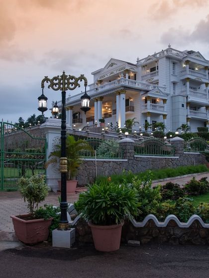 An ornate lamppost stands guard at the entrance, its classical design complementing the architectural style of the palace behind it.