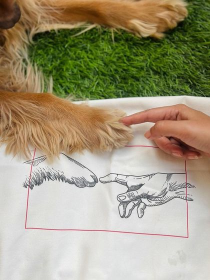 Recreating the iconic "Creation of Adam" pose with Posto's paw and my finger, just like the design on our new tote bag.