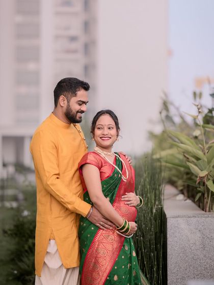 A lovely maternity portrait of a couple in traditional Indian outfits. Their gentle smiles and embrace capture the peaceful joy of this special time.