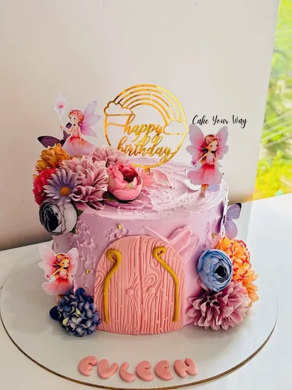 I bake your imaginations. This whimsical fairy door cake was a joy to create, with lots of floral and fairy details.