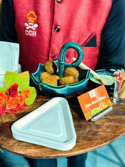 Our staff presenting a tray of Hara Bhara Kebabs. We pay attention to every detail, from the food itself to the beautiful serving dishes and presentation.