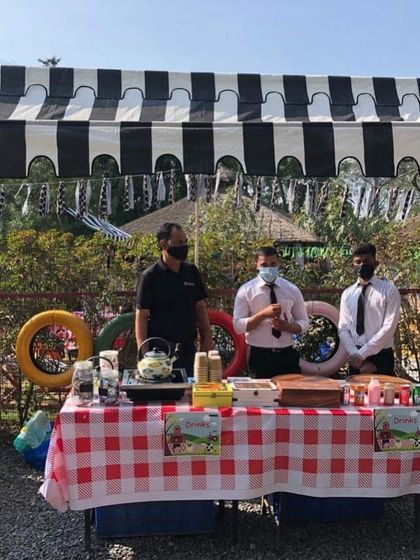 The drinks station at the farm-themed party. We set up a cute picnic-style table with a checkered cloth to serve refreshing beverages to the guests.