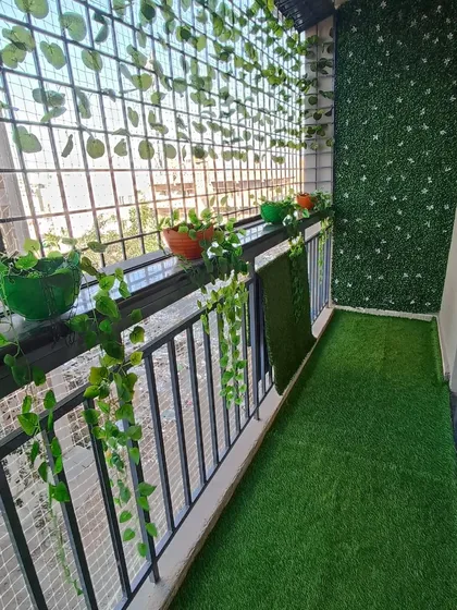 Another shot of the balcony makeover, showing how even a narrow space can become a cozy garden nook with the right combination of artificial greenery.