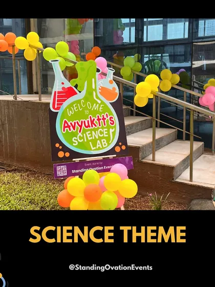 The entrance to a 'Science Lab' themed birthday party. A custom welcome sign and colorful balloon garlands shaped like molecules guide guests to the fun.