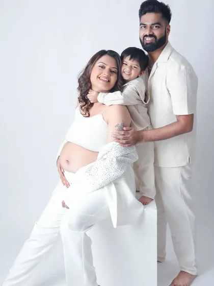 A beautiful maternity session that's also a family portrait. The older sibling gives his mom's baby bump a loving hug, excited to meet the new arrival.
