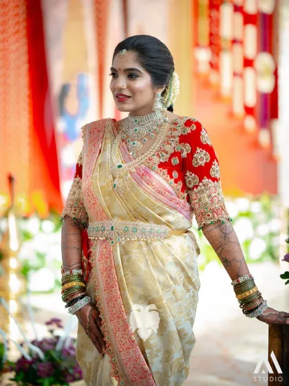 Seeing my creation on a bride's special day is the ultimate reward. Here is the lovely Bhavana, radiant in her custom red velvet Muhurtham blouse, where the zardosi work was designed to resemble a royal necklace. This is the emotion I strive to capture.