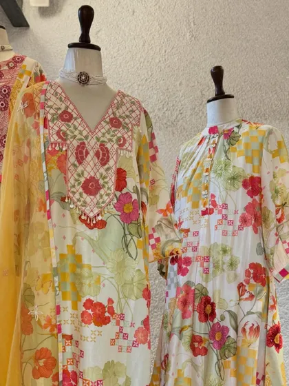 Festive florals for the celebrations ahead. This display features beautiful printed suits with delicate embroidery on the neckline.