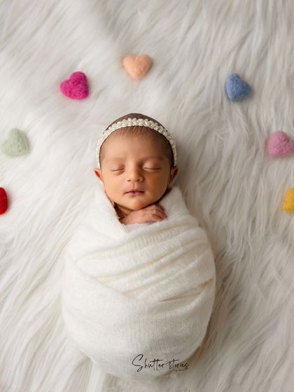 Another beautiful shot from the white and felt hearts series, showing a simple and timeless newborn portrait.