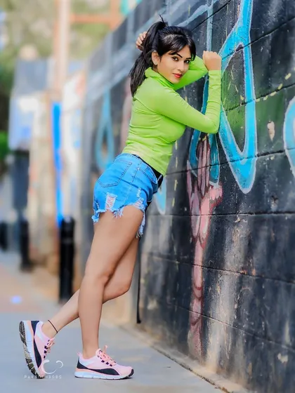 A full-length shot that showcases the entire casual-chic outfit. The pose is dynamic and full of energy.