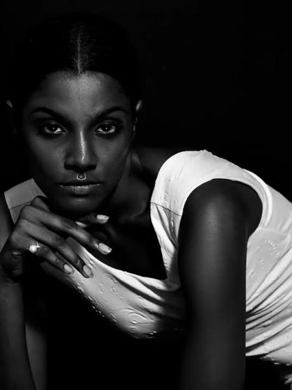 A variation of the intense black and white portrait, with the model's hand adding a new element to the composition.