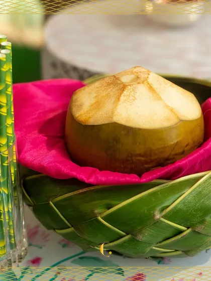 A tender coconut, ready to be served. We believe in offering natural and refreshing beverage options, presented beautifully in woven leaf baskets to enhance the tropical feel.