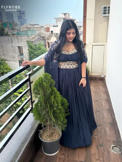 Slaying in a rented outfit. This client looks effortlessly chic in a navy blue pleated gown-style lehenga with an embroidered belt.