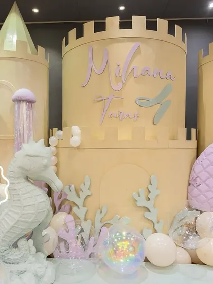 The stunning underwater castle I designed for Mihana's mermaid party, complete with a seahorse statue, coral details, and a mermaid tail accent.