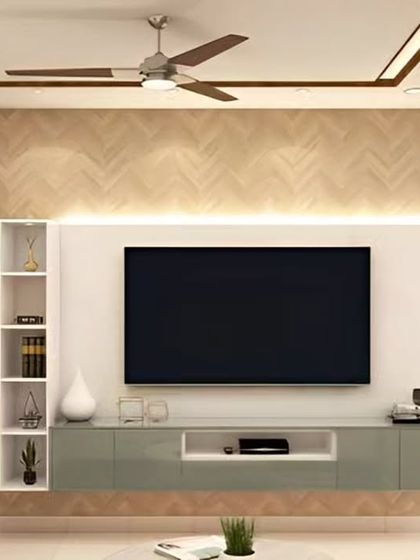 This TV unit design combines a herringbone-patterned wood wall with a sleek, light-green floating console. The integrated open shelving provides a stylish space for decor, creating a modern and refreshing look.