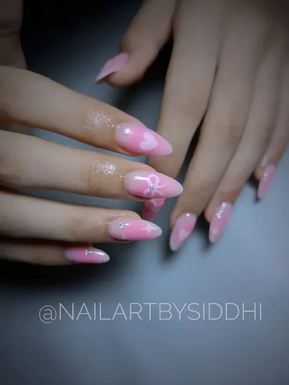 A cute and feminine design with pink ombre, subtle hearts, and bow details.