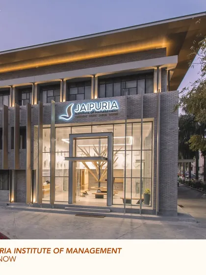 The entrance to the Jaipuria Institute of Management, showcasing the revitalized facade. The design combines modern glass and steel elements with a warm, textured brick, creating an identity that is both contemporary and grounded.