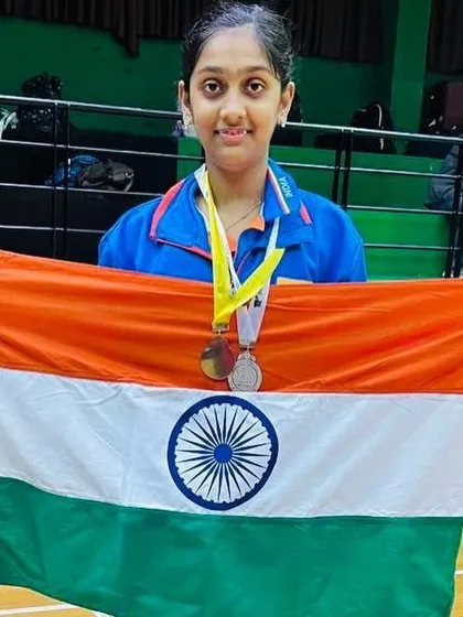 Divyanshi proudly holding the Indian flag with her medals from the South Asian Championship.