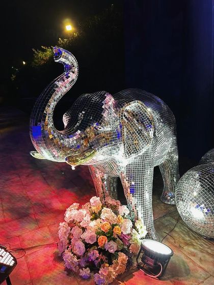 A disco-themed Sangeet in Jaisalmer, featuring a life-sized elephant statue covered in mirrors. It's a bold, glamorous statement piece.