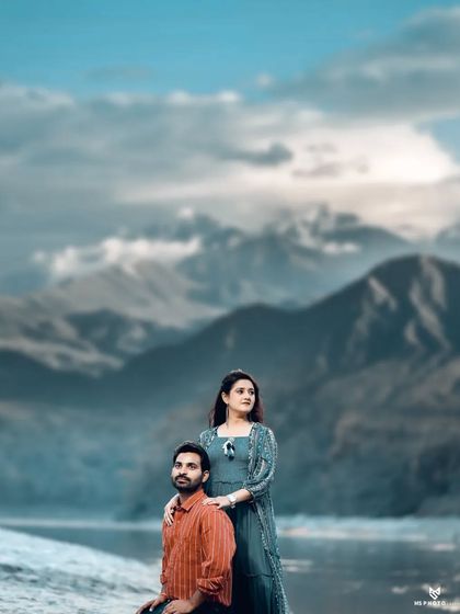 A majestic portrait of a couple against a mountain lake backdrop, showcasing the epic scenery I find for my shoots.