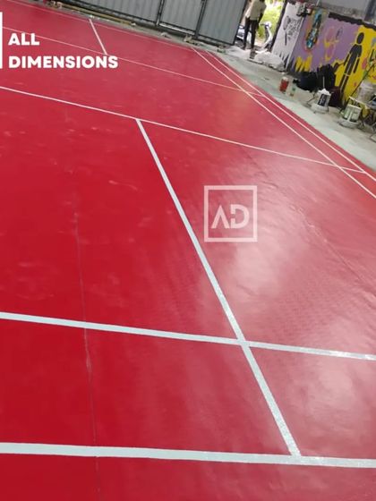 The finished court, ready for a game. The vibrant color and professional markings make the space look and feel like a professional sports arena.