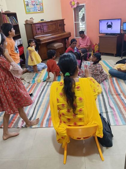 An interactive moment during the craft session, where children are up and moving, still buzzing with the energy of the story.