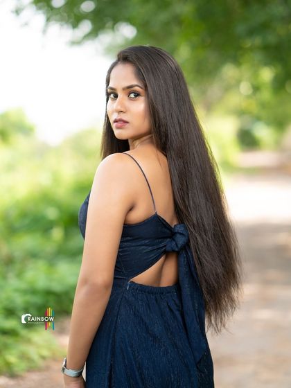 A back-view shot that highlights the design of the dress and the model's long hair.